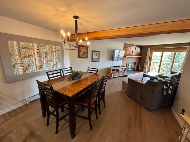 Dining area and open living room with mountain condo decor